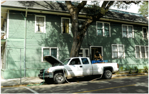 Fig 3: Accessing trees remote from water sources: Chris Mussolino mans a system utilizing an electric pump running off the truck battery to feed termiticide into a tree.